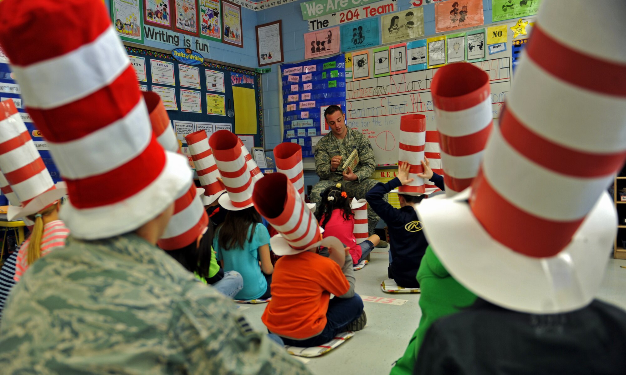Staff Sgt. Charles Cornacchio, a member of the 51st Security Forces Squadron, reads a book to third-grade students during Read Across America Day in celebration of Dr. Seuss’ Birthday at Osan Air Base, Republic of Korea, March 5, 2014. More than 50 Team Osan military members volunteered to read to 21 Osan American Elementary School classes. (U.S. Air Force photo/Senior Airman Siuta B. Ika)
