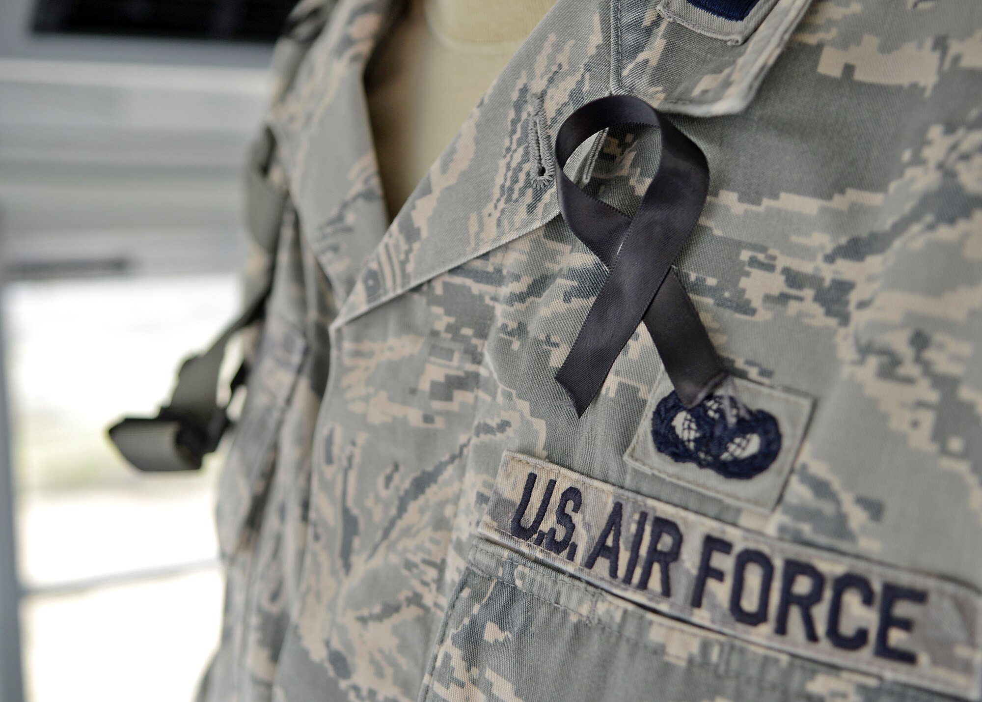Of the more than 30 personnel that took part in the ruck march, all were given a black ribbon to don during the 11.5-mile march to honor fallen security force members. (U.S. Air Force photo by Jet Fabara)