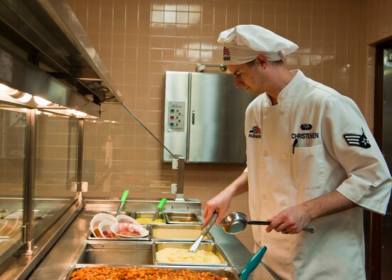 U.S. Air Force Senior Airman Cody Christensen, 99th Force Support Squadron food service worker, prepares food for serving at the Crosswinds dining facility March 3, 2014, at Nellis Air Force Base, Nev. The dining facility is increasing its food production to accommodate for the influx of troops participating in Red Flag 14-2. (U.S. Air Force photo by Airman 1st Class Thomas Spangler)