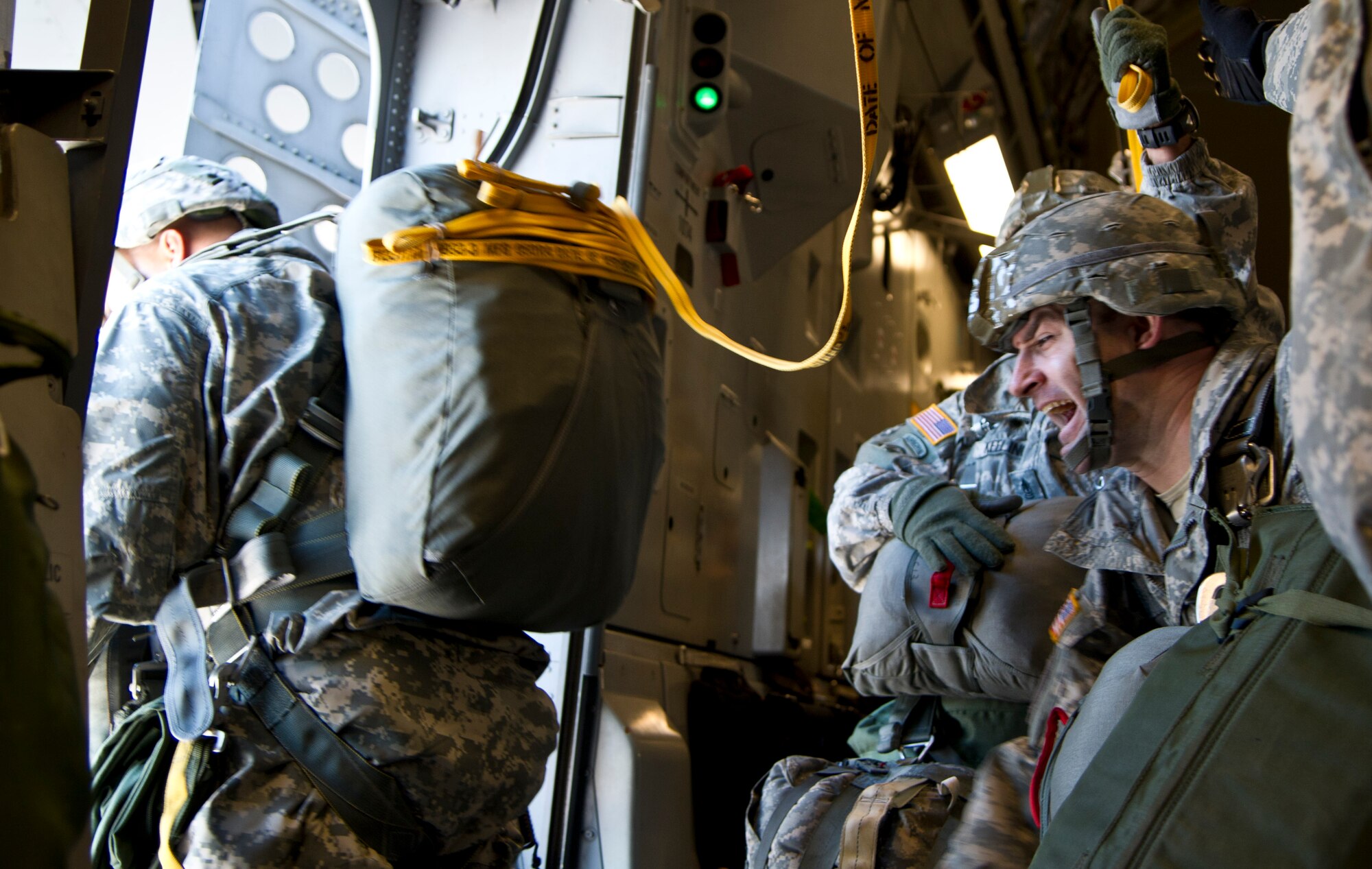 Sgt. 1st Class Corey Keeling yells to fellow jumpers as they exit a C-17 Globemaster III from the 517th Airlift Squadron over Malemute Drop Zone at Joint Base Elmendorf-Richardson, Alaska, Feb. 27, 2014. Keeling is assigned to the 2nd Battalion, 377th Field Artillery, 4th Infantry Brigade Combat Team (Airborne), 25th Infantry Division. (U.S. Air Force photo/Staff Sgt. Sheila deVera)