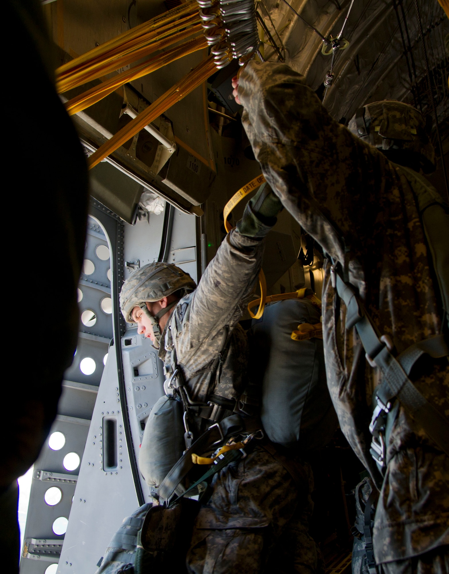Army 1st Lt. Shad Hughes, 725th Brigade Support Battalion, 4th Infantry Brigade Combat Team (Airborne), 25th Infantry Division, prepares to jump from a C-17 Globemaster III from the 517th Airlift Squadron as part of the non-maneuverable canopy T-11 personnel parachute system proficiency jump over Malemute Drop Zone, Joint Base Elmendorf-Richardson, Alaska, Feb. 27, 2014. The T-11 parachute replaced the T-10 Delta parachute that has been widely used by the Army. (U.S. Air Force photo/Staff Sgt. Sheila deVera)