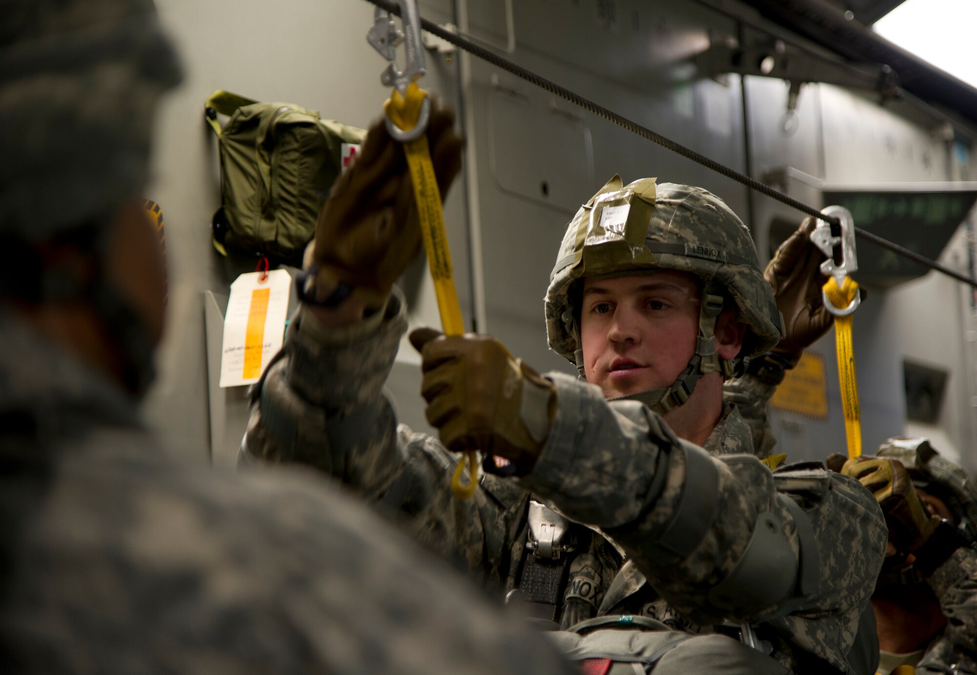 Army Capt. Von Lennox, 725th Brigade Support Battalion, 4th Infantry Brigade Combat Team (Airborne), 25th Infantry Division, inspects his static line prior to jumping from a C-17 Globemaster III over Malemute Drop Zone at Joint Base Elmendorf-Richarson, Alaska, Feb. 27, 2014. (U.S. Air Force photo/Staff Sgt. Sheila deVera) 