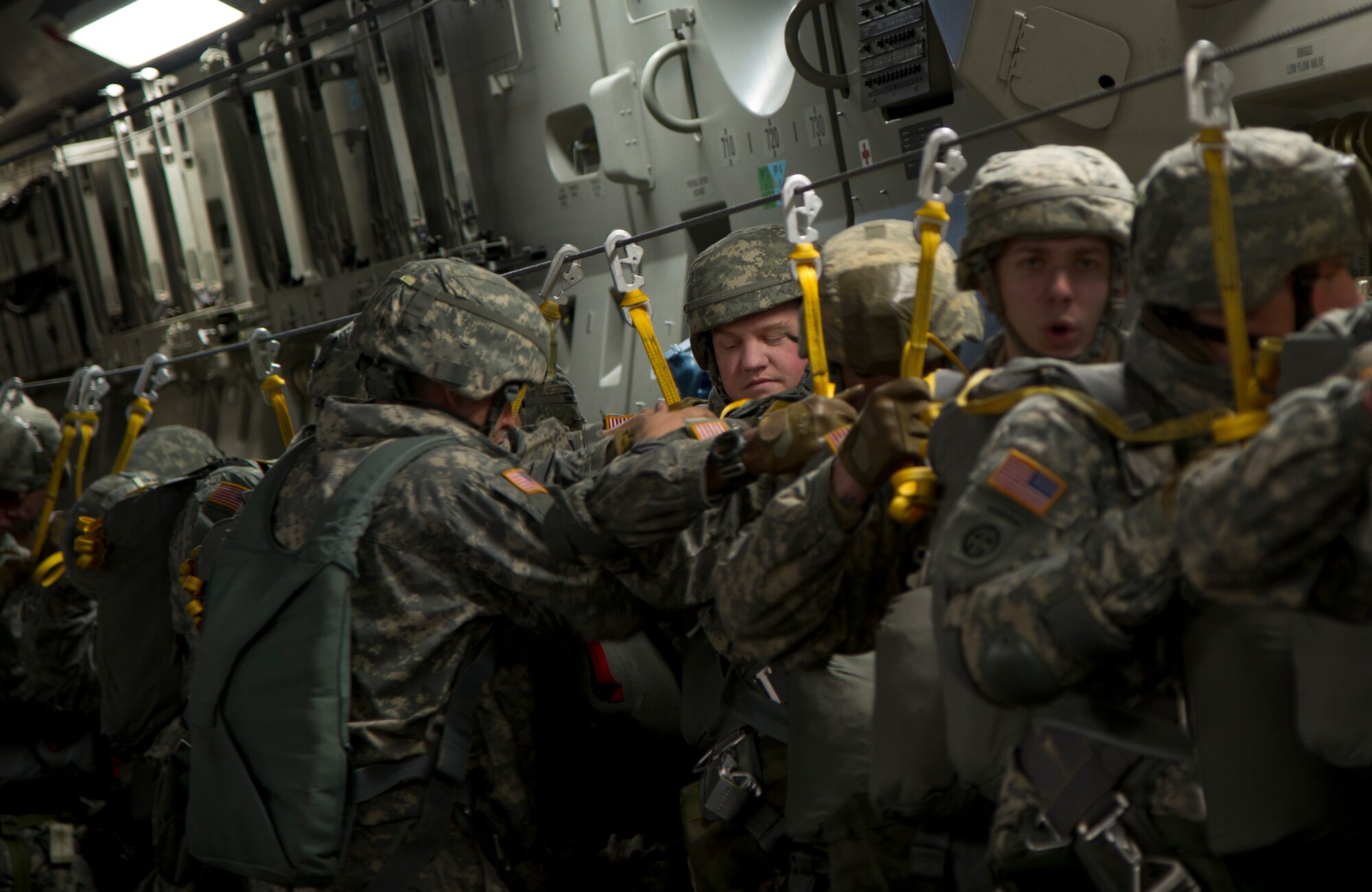 Team leader Sgt. Clayton Word (left), 725th Brigade Support Battalion, 4th Infantry Brigade Combat Team (Airborne), 25th Infantry Division, inspects a Soldier’s static line prior to the jump over Malemute Drop Zone at Joint Base Elmendorf-Richardson, Alaska, Feb. 27, 2014. Jumpmasters are the expert paratroopers train and teach Soldiers techniques for jumping from airplanes. (U.S. Air Force photo/Staff Sgt. Sheila deVera) 