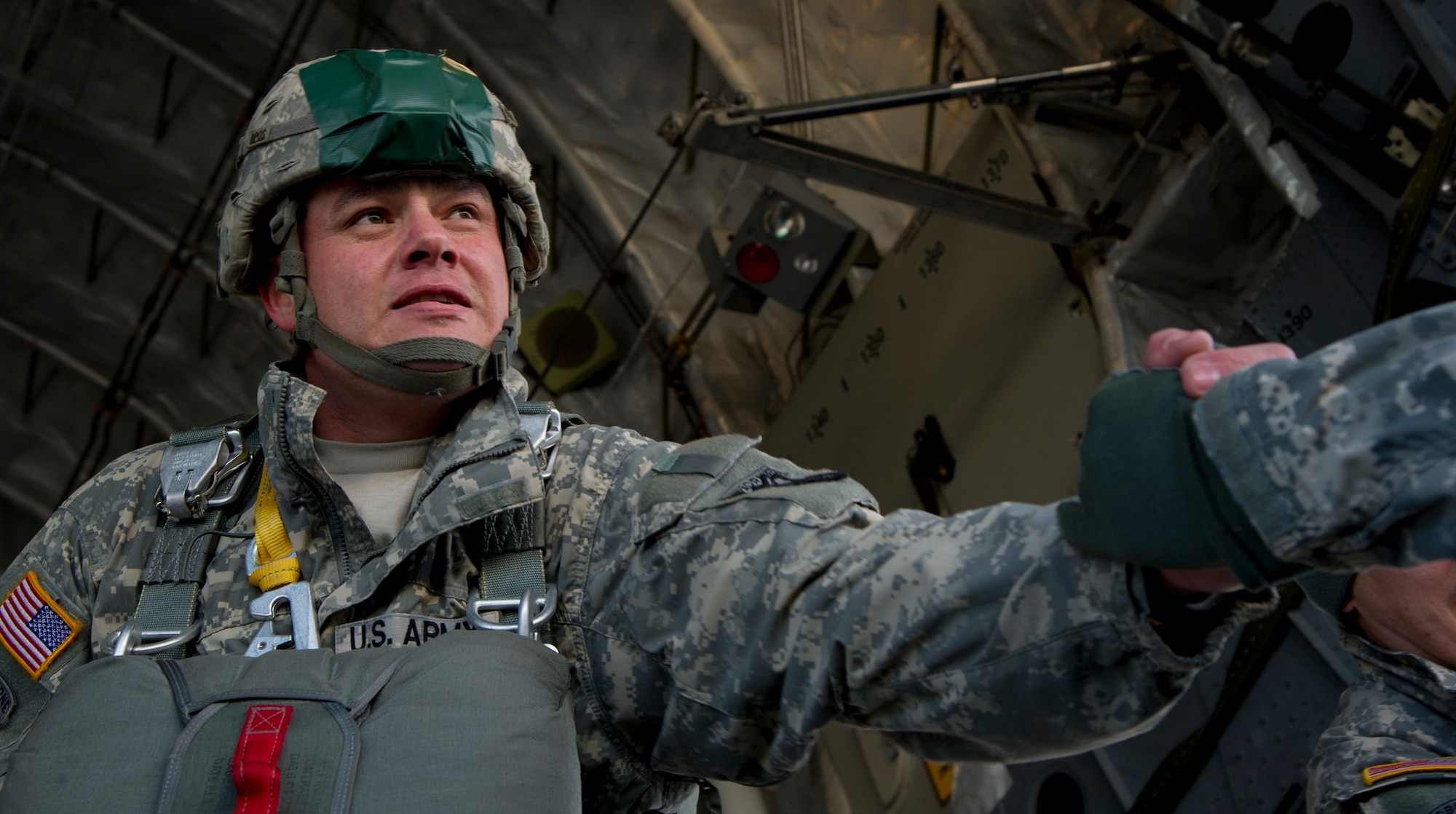 Sgt. 1st Class Kenneth Gray assigned to the 425th Brigade Special Troops Battalion, 4th Infantry Brigade Combat Team (Airborne), 25th Infantry Division, helps a fellow Soldier board a C-17 Globemaster III, Feb. 27, 2014, at Joint Base Elmendorf-Richardson, Alaska. The 425th BSTB conducted a non-maneuverable canopy T-11 personnel parachute system proficiency jump over Malemute Drop Zone. (U.S. Air Force photo/Staff Sgt. Sheila deVera)