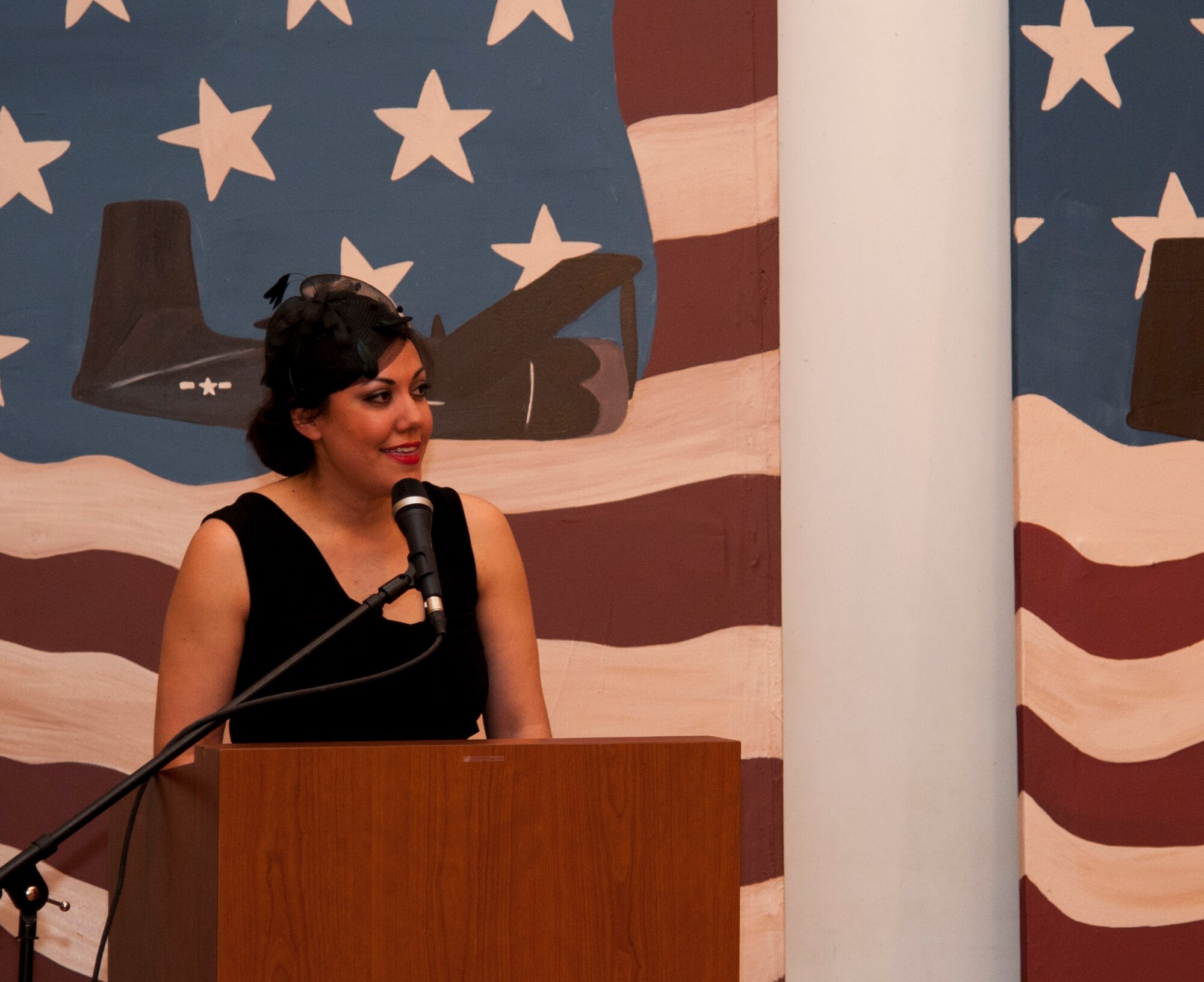 Stacie Hilby, Officer Spouses’ Club auction chair, greets bidders as they arrive and describes the plans for the night at the J.P. Kress building in Del Rio, Texas, March 1, 2014. The OSC auction helps raise money for scholarships for local students. (U.S. Air Force photo/Airman 1st Class Jimmie D. Pike)