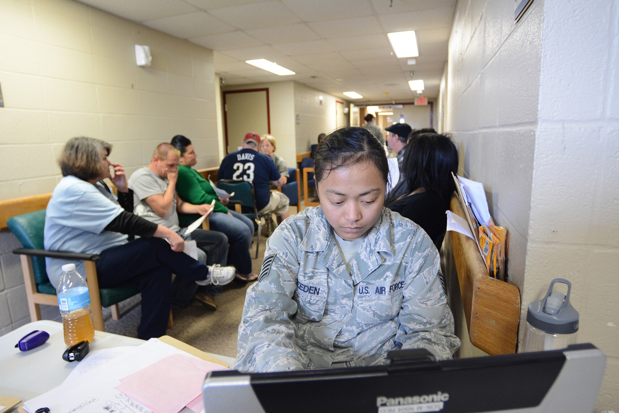 Tech. Sgt. Sharon Breeden, 115th Medical Group medical administrator, checks optometry patients in during Cajun Care 2014 in Abbeville, La., March 2, 2014. During the 10-day mission, residents of Abbeville, La., and the surrounding areas could receive free optometry, dental and medical services from Air National Guard and Navy personnel. (Air National Guard photo by Senior Airman Andrea F. Liechti)