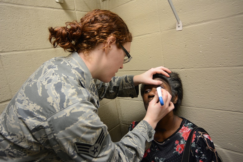 Senior Airman Deborah Cerwonka, 177th Medical Group optometry technician, checks a patient’s eyes for glaucoma during Cajun Care 2014 in Abbeville, La., March 2, 2014. During the 10-day mission, residents of Abbeville, La., and the surrounding areas could receive free optometry, dental and medical services. (Air National Guard photo by Senior Airman Andrea F. Liechti)