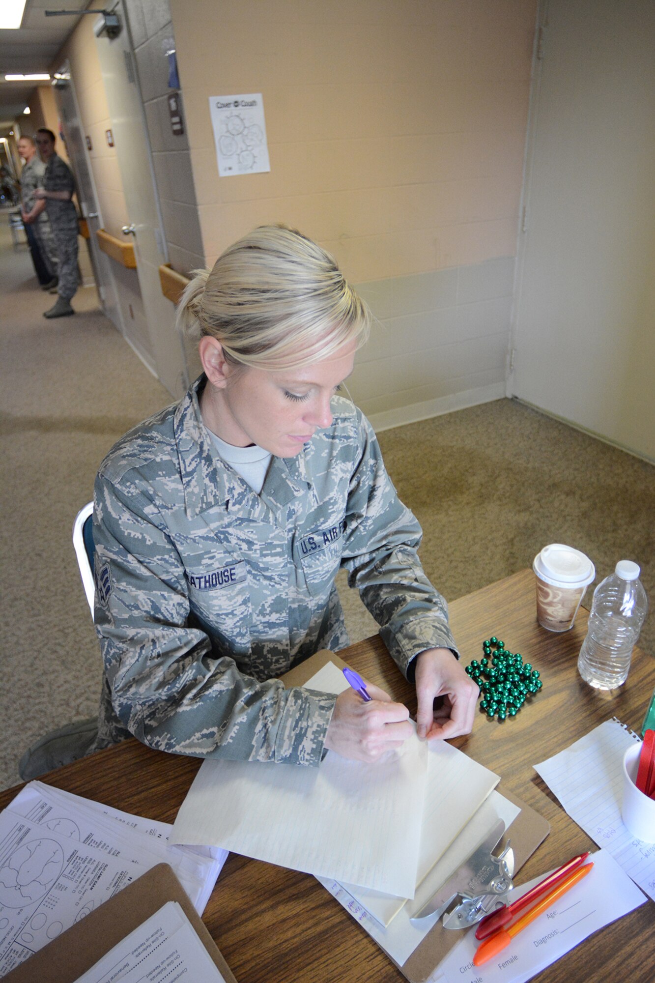 Senior Airman Jackie Greathouse, 115th Medical Group medical technician, checks medical patients in during Cajun Care 2014 in Abbeville, La., March 2, 2014. During the 10-day mission, residents of Abbeville, La., and the surrounding areas could receive free optometry, dental and medical services from Air National Guard and Navy personnel. (Air National Guard photo by Senior Airman Andrea F. Liechti)