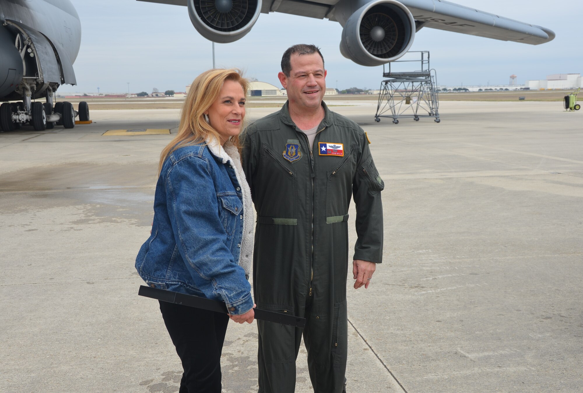 (Right) Col. Adam Willis, 433rd Operations Group commander along with wife, Elyse, bid the 433rd Airlift Wing farewell after his “fini flight,” Mar. 4, 2014. Willis leaves the “Alamo Wing” to be the commander at the 908th Airlift Wing, Maxwell AFB, Ala. (U.S. Air Force photo by Senior Master Sgt. Minnie Jones /Released)