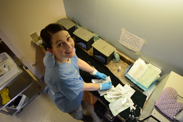 Master Sgt. Emily Decker, 115th Medical Group dental technician, packages sanitized dental instruments during Cajun Care 2014 in Abbeville, La., March 2, 2014. During the 10-day mission, Air National Guard and Navy personnel pulled more than 1,000 teeth. (Air National Guard photo by Senior Airman Andrea F. Liechti)