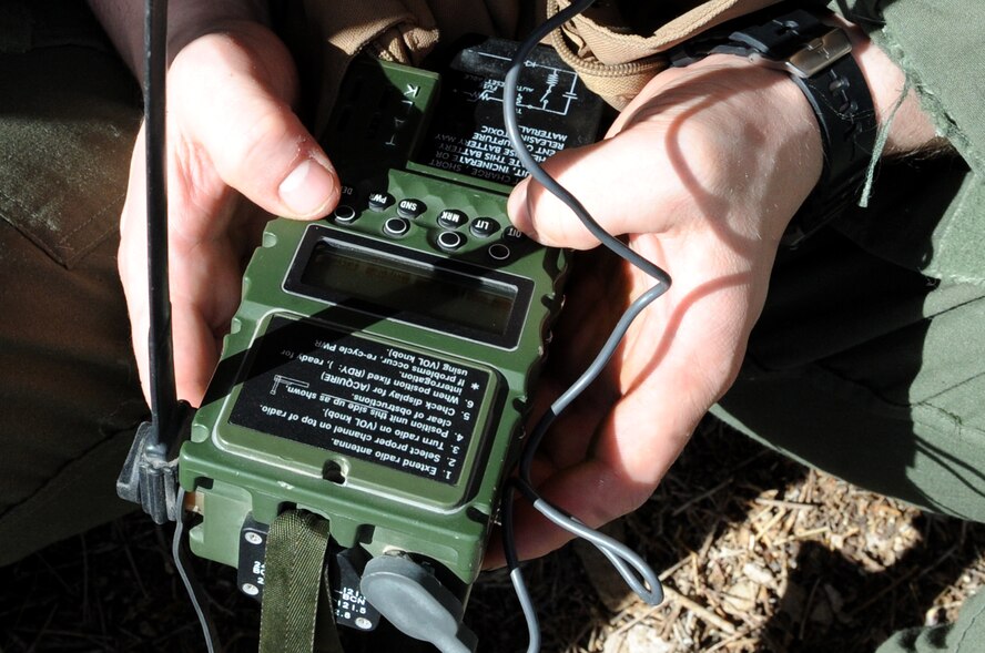 U.S. Air Force 1st Lt. Ryan Gipson, 336th Fighter Squadron F-15E Strike Eagle Pilot, establishes communication with nearby aircraft from a rock formation on a Southern Nevada range March 4, 2014. As part of Red Flag 14-2, Gipson eluded capture for approximately four hours while communicating with search and rescue aircraft during a survival, evasion, resistance and escape exercise. (Air Force photo/Staff Sgt. Chuck Broadway)