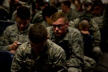Airmen from the 5th Maintenance Group and 5th Operations Support Squadron sit in Dock 9 at Minot Air Force Base, N.D., March 5, 2014, waiting to board their plane headed to Andersen AFB, Guam, for a six month deployment. Movement of U.S. Air Force bombers into the Western Pacific has been ongoing since March 2004, as the U.S. Pacific Command adjusts its force posture to maintain a prudent deterrent capability. (U.S. Air Force photo/Senior Airman Brittany Y. Auld)