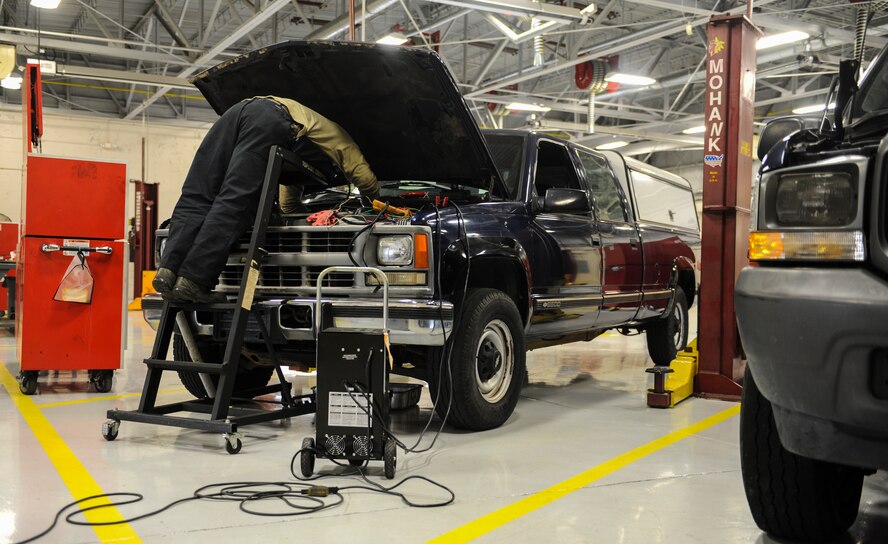 U. S. Air Force Senior Airman Josh Flodder, 23d Logistics Readiness Squadron vehicle vehicular equipment maintenance journeyman, looks under the hood of a truck at Moody Air Force Base, Ga., March 5, 2014. Flodder ran a variety of tests on the vehicle to pinpoint any mechanical  issues. (U.S. Air Force photo by Airman 1st Class Alexis Millican/Released)