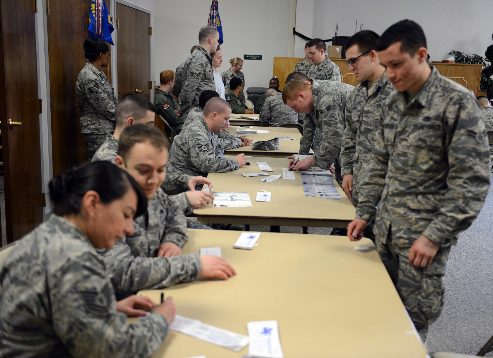 Airmen of Team McChord sign their Air Force Assistance Fund forms as part of the Team McChord AFAF kick-off event at the McChord Field Chapel Support Center, Feb. 28, 2014 at Joint Base Lewis-McChord, Wash. For more information on donating contact your unit representative. (U.S. Air Force photo/Master Sgt. Todd Wivell)
 