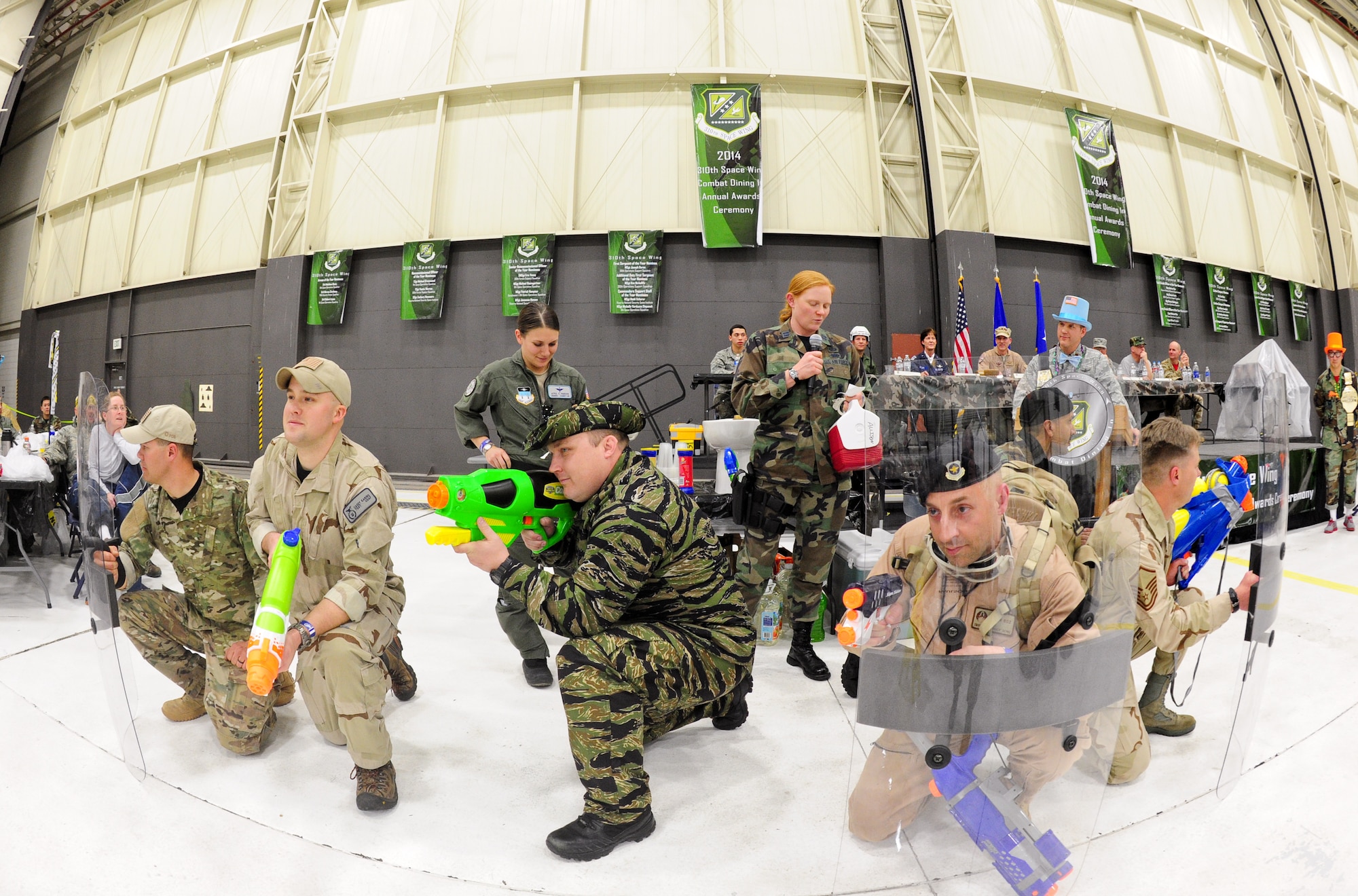 Air Force Reservists from the 710th Security Forces Squadron protect the “grogg bowl” as it’s being filled March 1, 2014, during the 310th Space Wing's Combat Dining In/Annual Awards Ceremony at Peterson Air Force Base, Colo. The wing sponsored the event to both recognize its annual award winners and bring together the Reservists to enjoy an evening of esprit de corps, unit morale and camaraderie. (U.S. Air Force photo/Tech. Sgt. Nicholas B. Ontiveros)