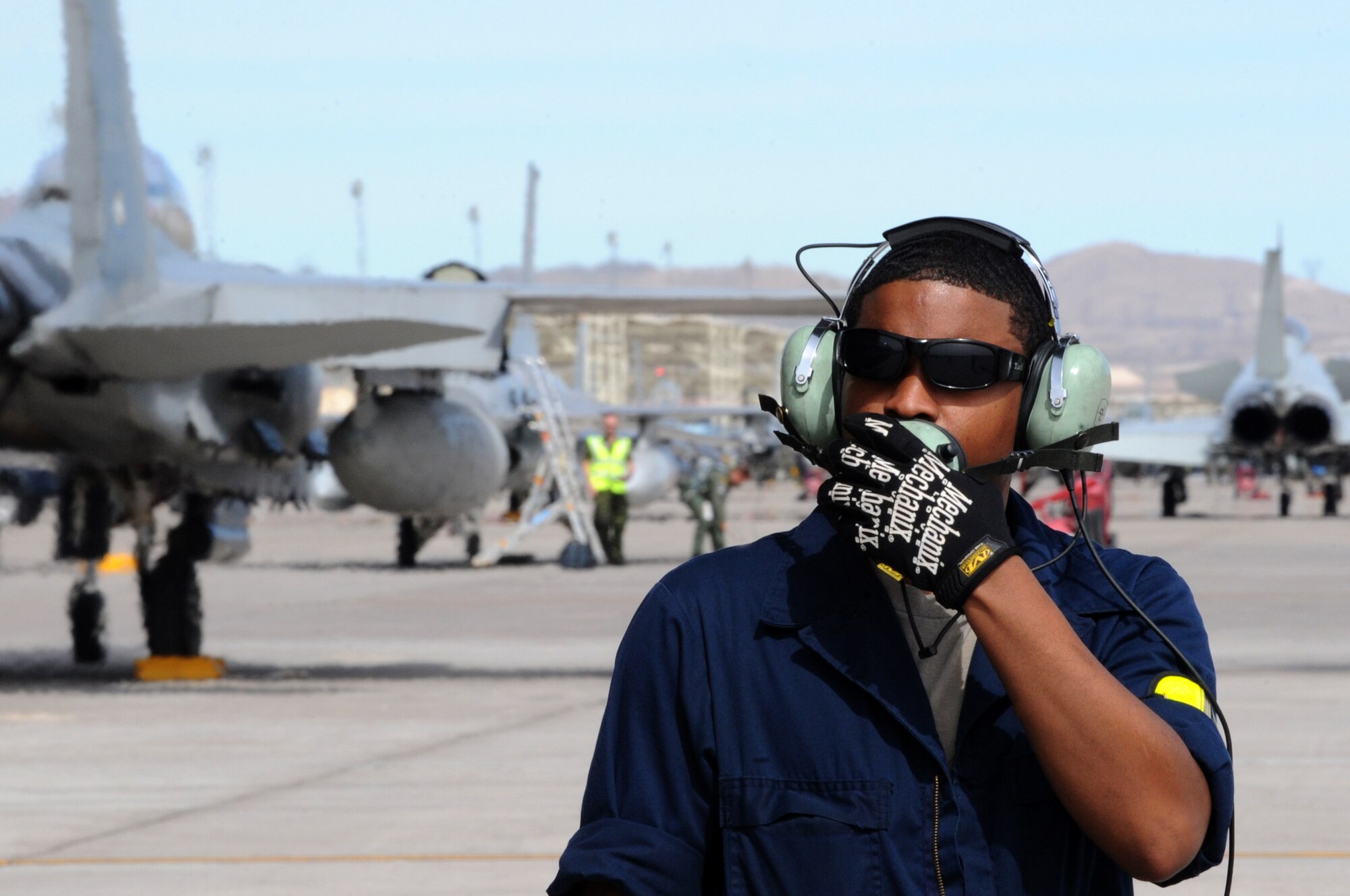 U.S. Air Force Airman 1st Class Brian Langston, 4th Aircraft Maintenance Squadron crew chief, communicates with aircrew members during a pre-flight check March 3, 2014, during Red Flag 14-2 at Nellis Air Force Base, Nev. During the first day of the exercise, 4th Fighter Wing personnel were credited with completed more than 12 sorties. (Air Force photo/Staff Sgt. Chuck Broadway)