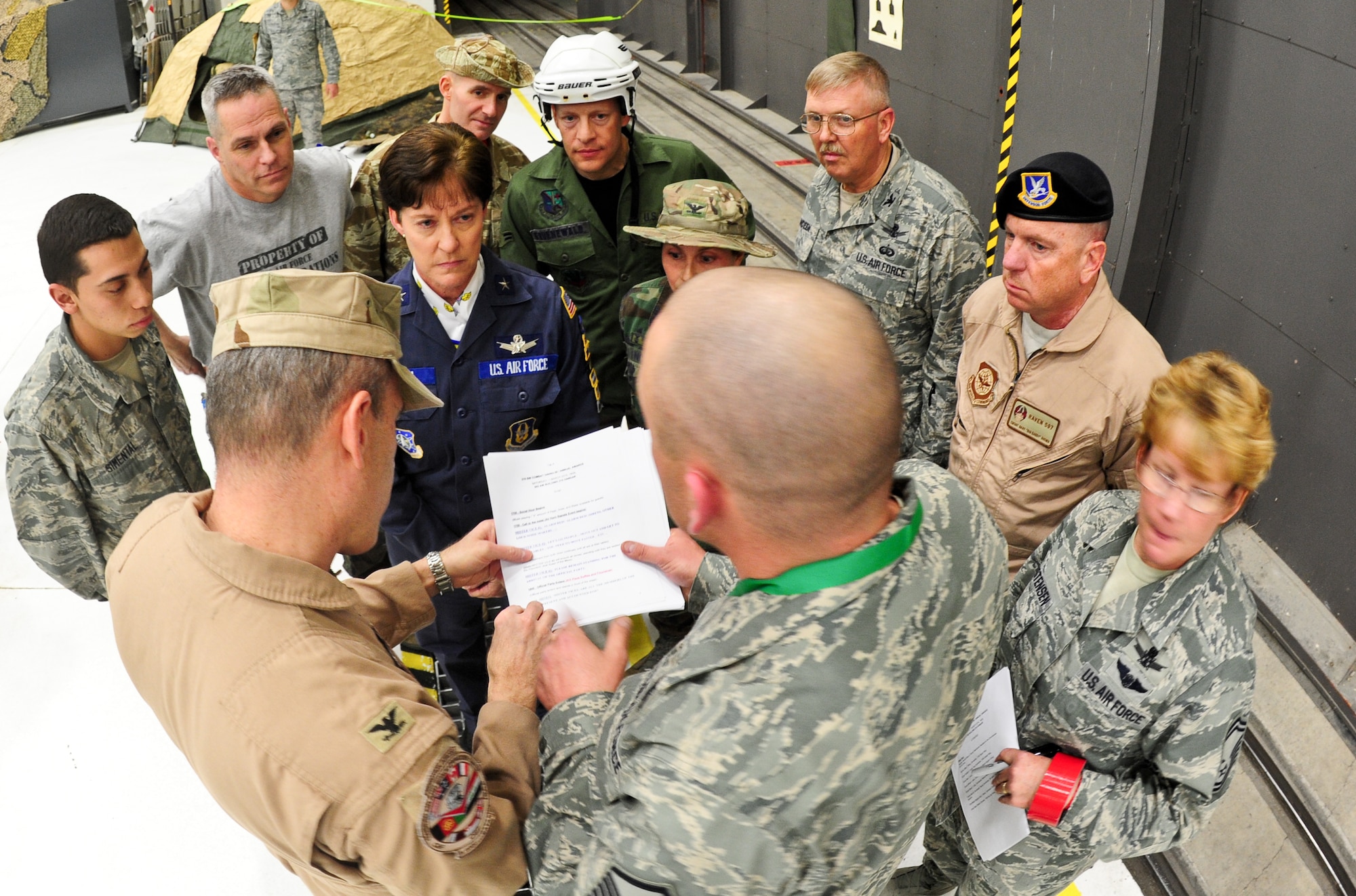 Air Force Reservists and key players receive their head table ceremony rules and procedures March 1, 2014, at the 310th Space Wing's Combat Dining In/Annual Awards Ceremony at Peterson Air Force Base, Colo. The wing sponsored the event to both recognize its annual award winners and bring together the Reservists to enjoy an evening of esprit de corps, unit morale and camaraderie. (U.S. Air Force photo/Tech. Sgt. Nicholas B. Ontiveros)