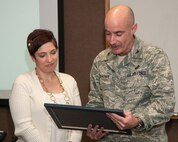 HANSCOM AIR FORCE BASE, Mass. – 66th Air Base Group Commander Col. Lester A. Weilacher reads an award to Monica Hyatt before presenting her the Hanscom Key Spouse of the Year award at the Airman and Family Readiness Center March 5. Hyatt was presented the award prior to a training session for Key Spouse members. (U.S. Air Force photo by Mark Herlihy)