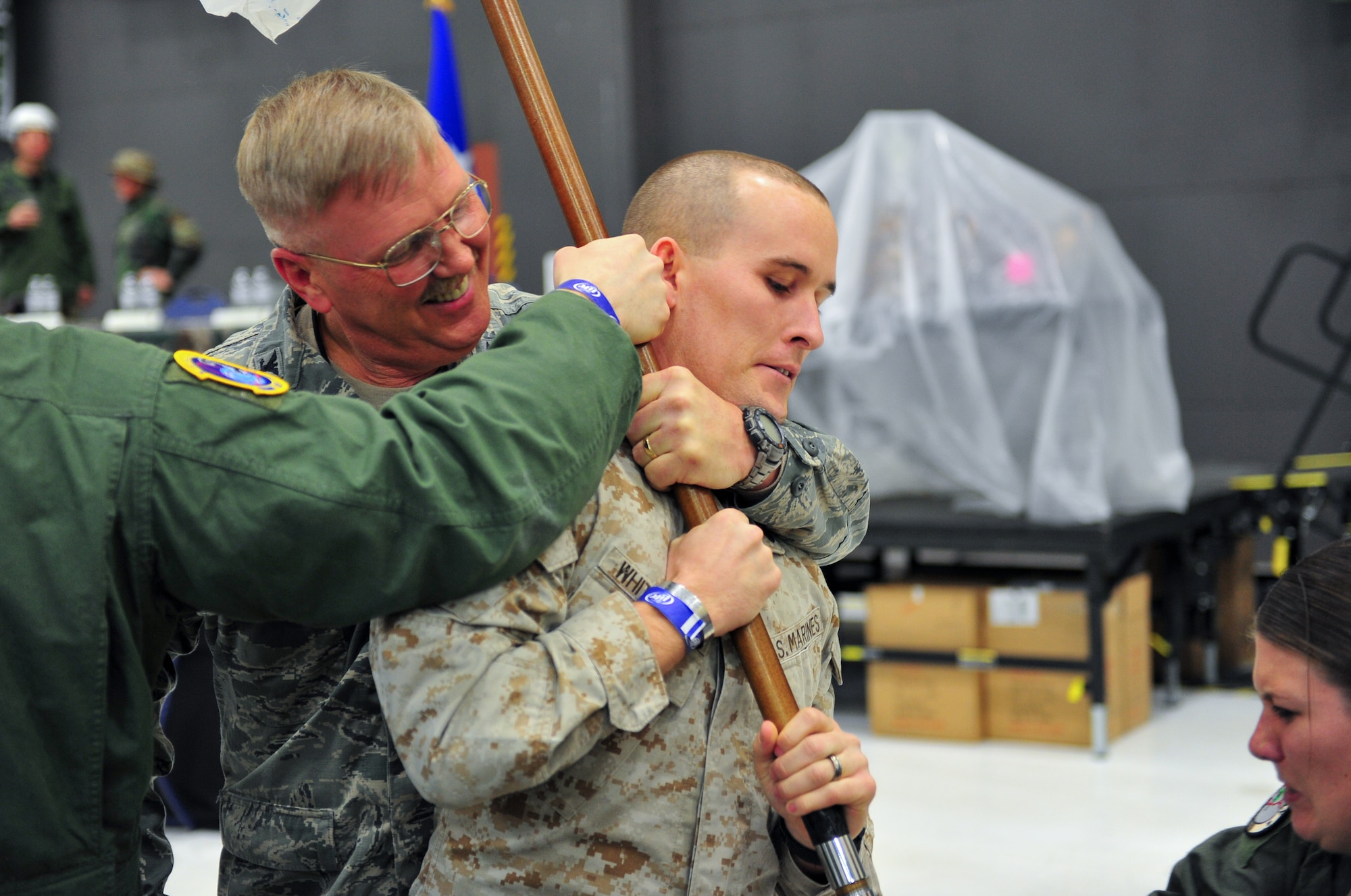 Air Force Reserve Col. Neal J. Landeen apprehends a guidon ”thief” March 1, 2014, during the 310th Space Wing's Combat Dining In/Annual Awards Ceremony at Peterson Air Force Base, Colo. The wing sponsored the event to both recognize its annual award winners and bring together the Reservists to enjoy an evening of esprit de corps, unit morale and camaraderie.Landeen commands the 310th Mission Support Group. (U.S. Air Force photo/Tech. Sgt. Nicholas B. Ontiveros)