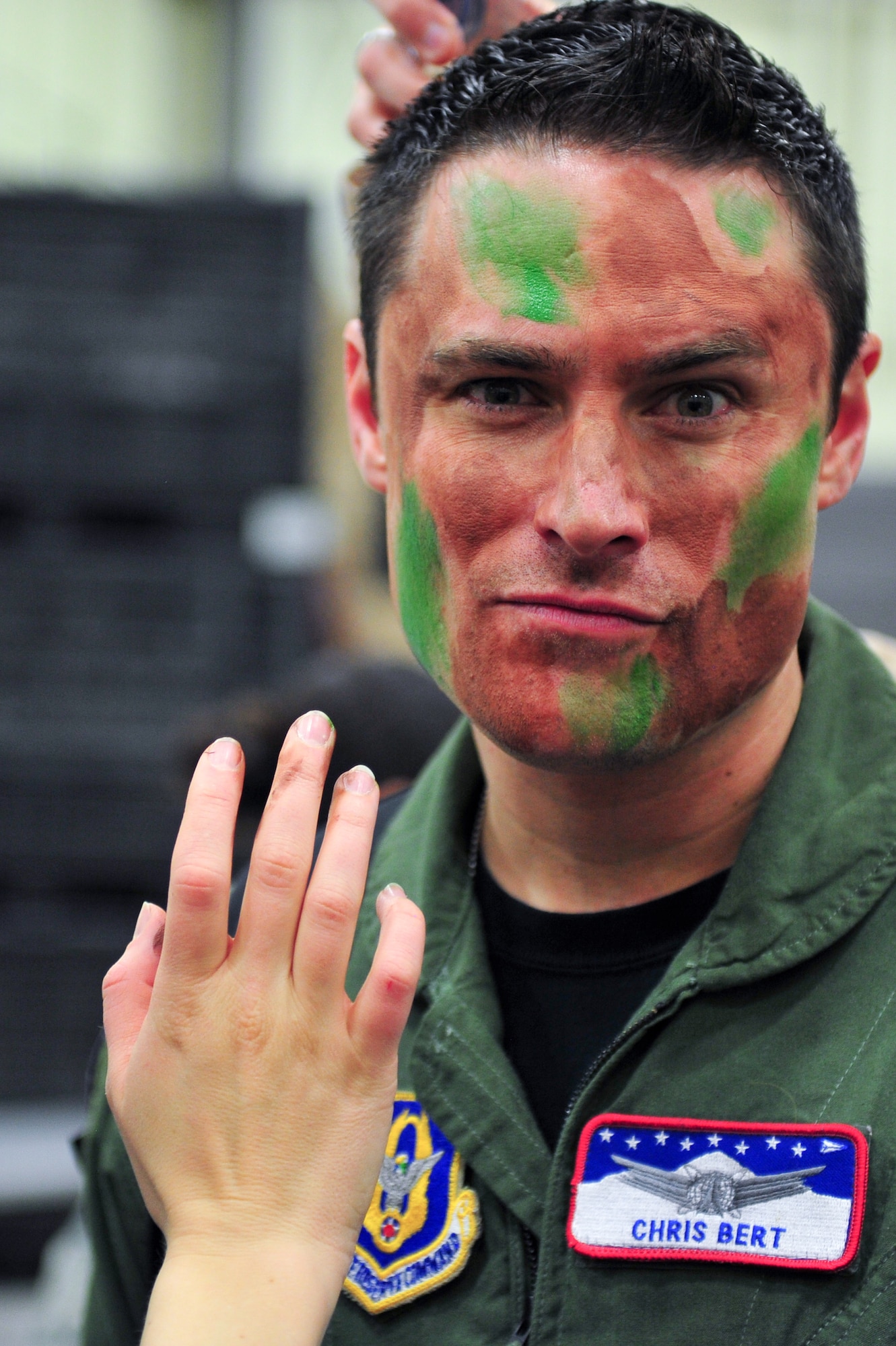 Air Force Reserve Capt. Christopher Bert has camouflage makeup applied March 1, 2014, before the start of the 310th Space Wing's Combat Dining In/Annual Awards Ceremony at Peterson Air Force Base, Colo. The wing sponsored the event to both recognize its annual award winners and bring together the Reservists to enjoy an evening of esprit de corps, unit morale and camaraderie. (U.S. Air Force photo/Tech. Sgt. Nicholas B. Ontiveros)