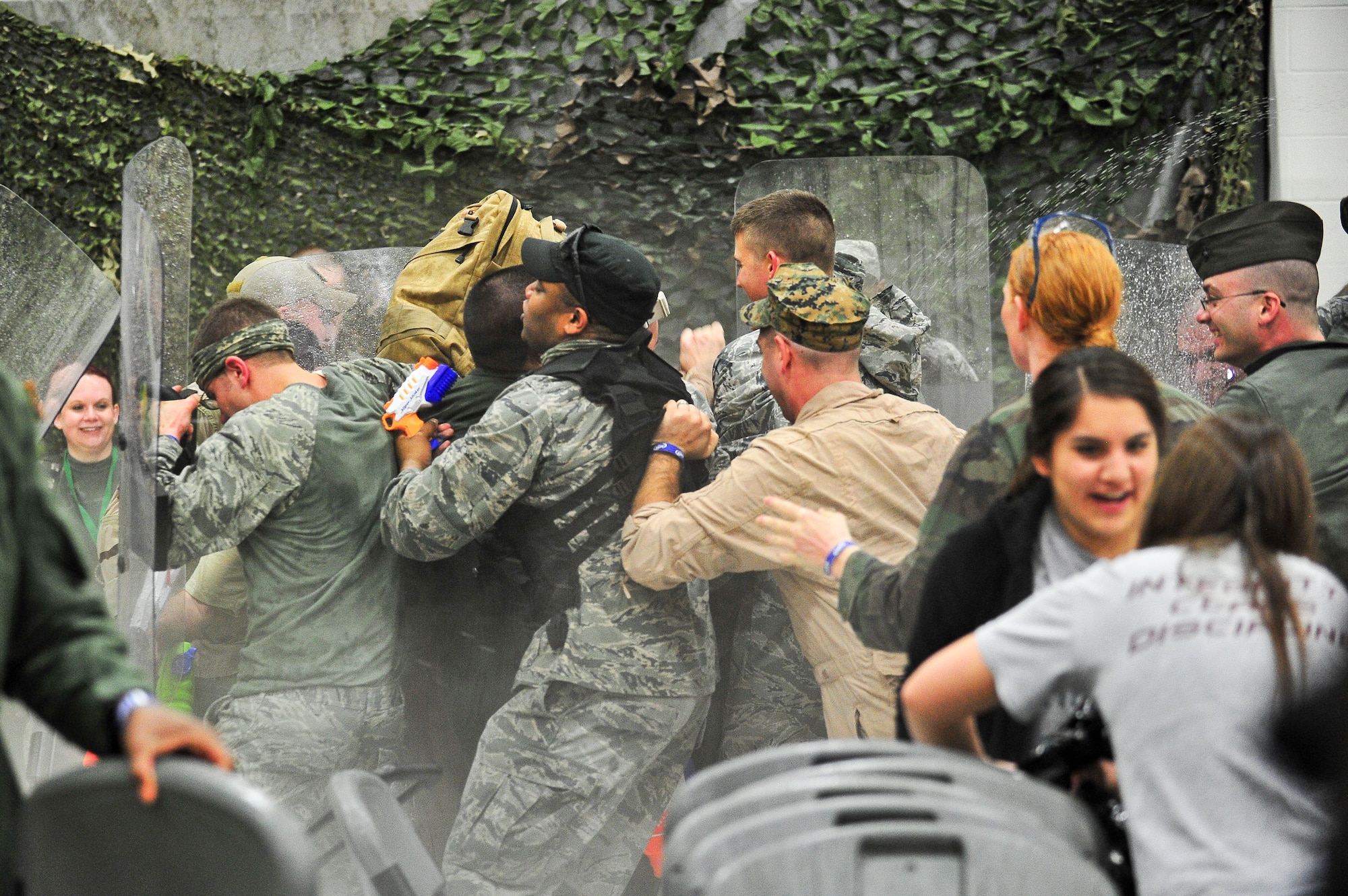 Air Force Reservists try to stand their ground in the middle of a water fight March 1, 2014, during the 310th Space Wing's Combat Dining In/Annual Awards Ceremony at Peterson Air Force Base, Colo. The wing sponsored the event to both recognize its annual award winners and bring together the Reservists to enjoy an evening of esprit de corps, unit morale and camaraderie. (U.S. Air Force photo/Tech. Sgt. Nicholas B. Ontiveros)