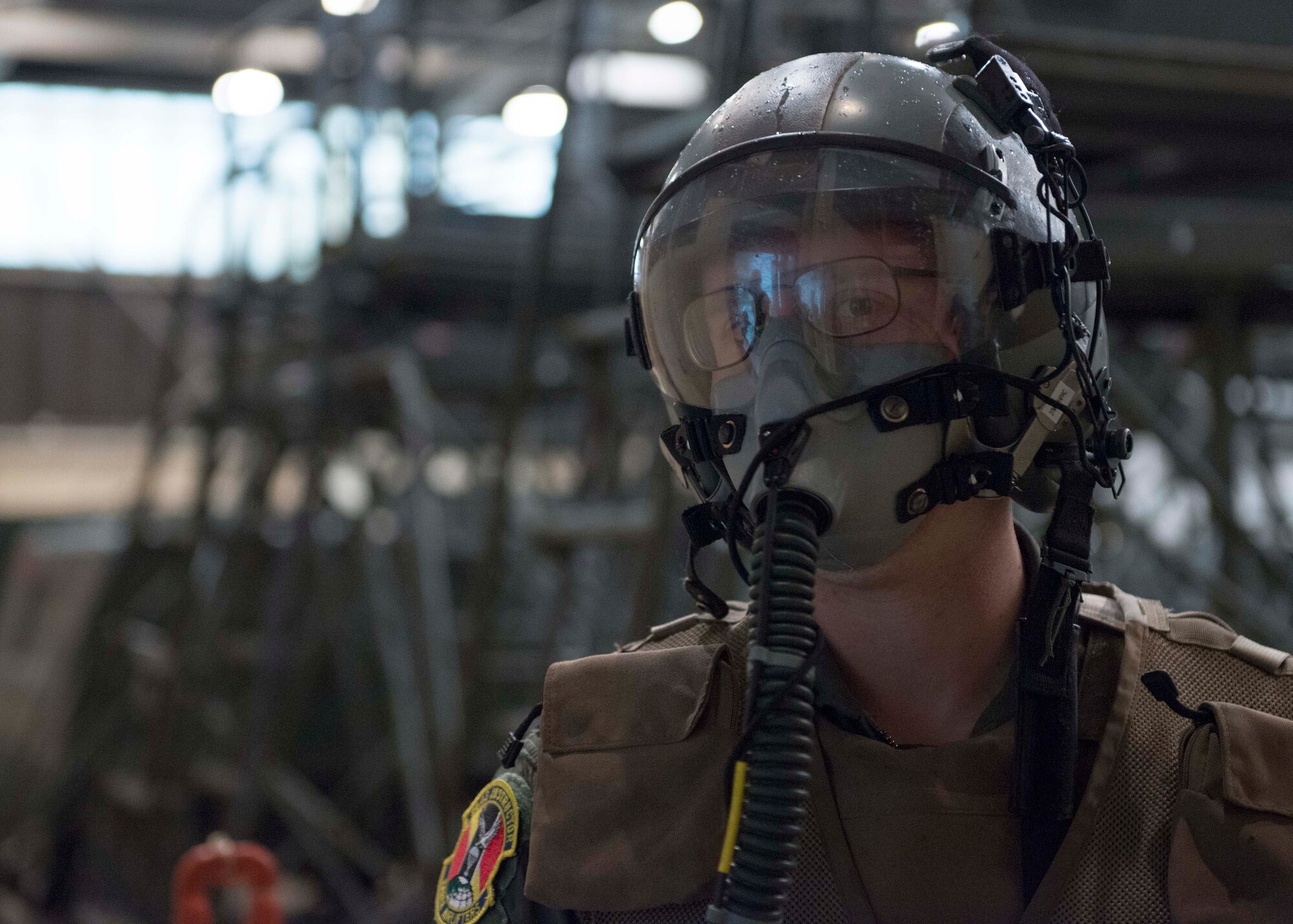 An Airman dons his aircrew chemical defense ensemble during the Samurai Readiness Inspection at Yokota Air Base, Japan, March 5, 2014.  Yokota entered the Samurai Readiness Inspection week, ensuring the base is ready to defend and deter enemy aggression.  (U.S. Air Force photo by Airman 1st Class David Danford / released)