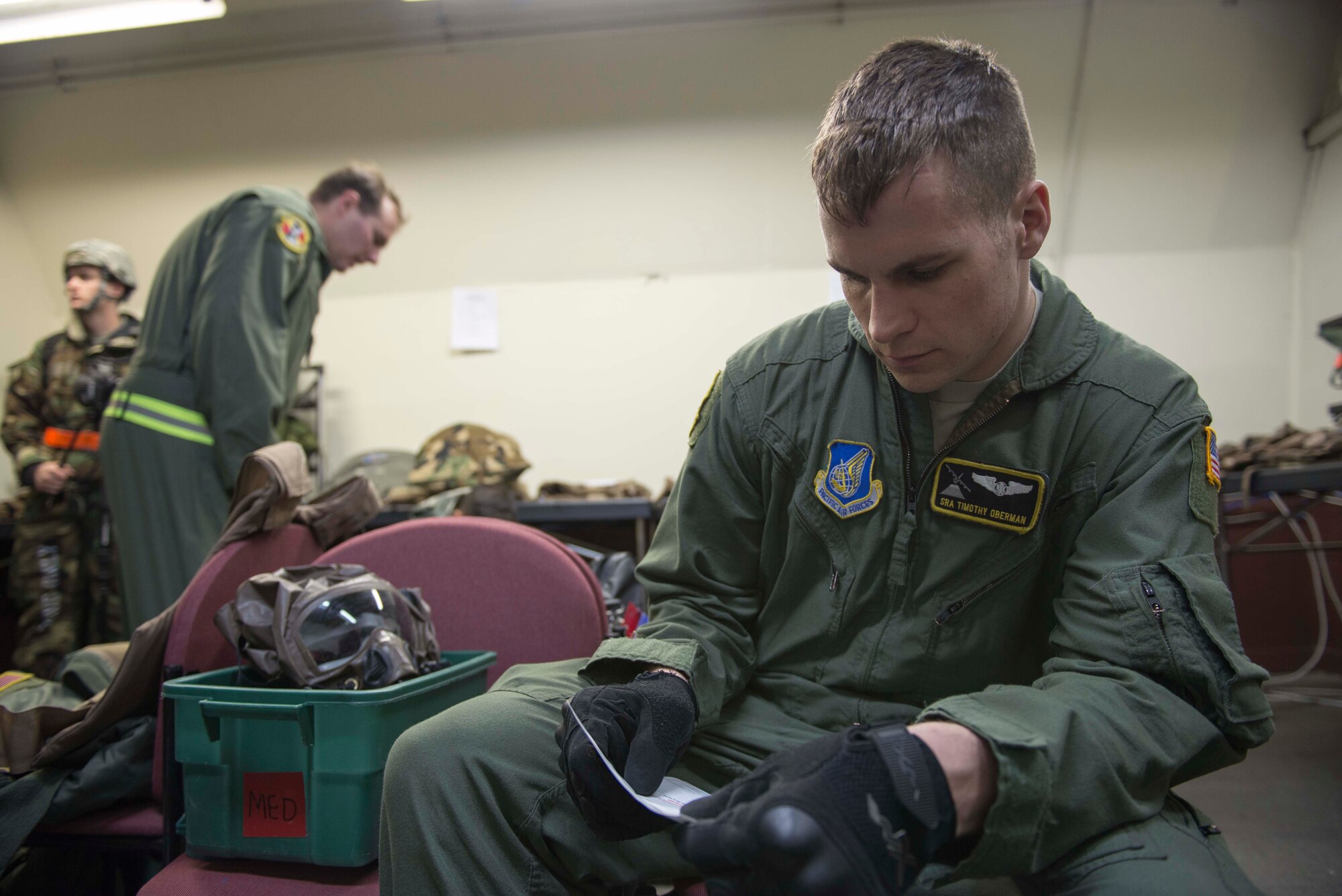 Senior Airman Timothy Oberman, 36th Airlift Squadron loadmaster, reads through a checklist during the Samurai Readiness Inspection at Yokota Air Base, Japan, March 5, 2014.  Yokota Airmen were challenged with unique scenarios, enhancing their proficiency to support regional stability in the Pacific theater. (U.S. Air Force photo by Airman 1st Class David Danford / released)