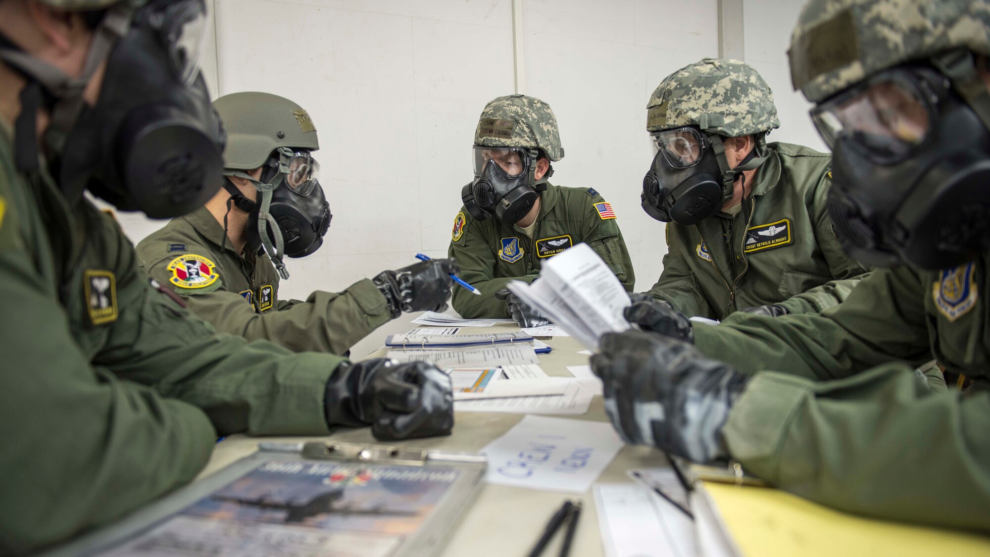 Members of the 36th Airlift Squadron hold a strategic meeting during the Samurai Readiness Inspection at Yokota Air Base, Japan, March 5, 2014.  Yokota Airmen were challenged with numerous scenarios such as a chemical warfare attack.  (U.S. Air Force photo by Airman 1st Class David Danford / released)