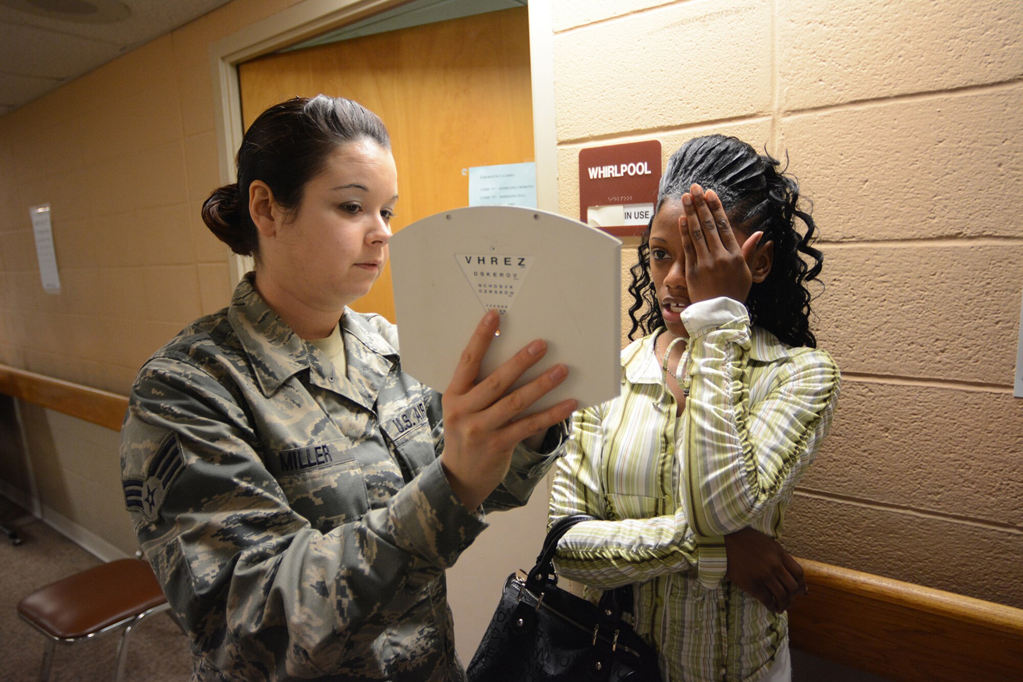 Senior Airman Spring Miller, 115th Medical Group optometry, tests a patient’s eyesight during Cajun Care 2014 in Abbeville, La., March 2, 2014. Cajun Care 2014 took place in an old nursing home and was modified to meet the needs of the medical personnel. After the eighth day of the 10-day mission, Air National Guard, Navy and Army personnel had already given free medical care to more than 2,100 people. (Air National Guard photo by Senior Airman Andrea F. Liechti)