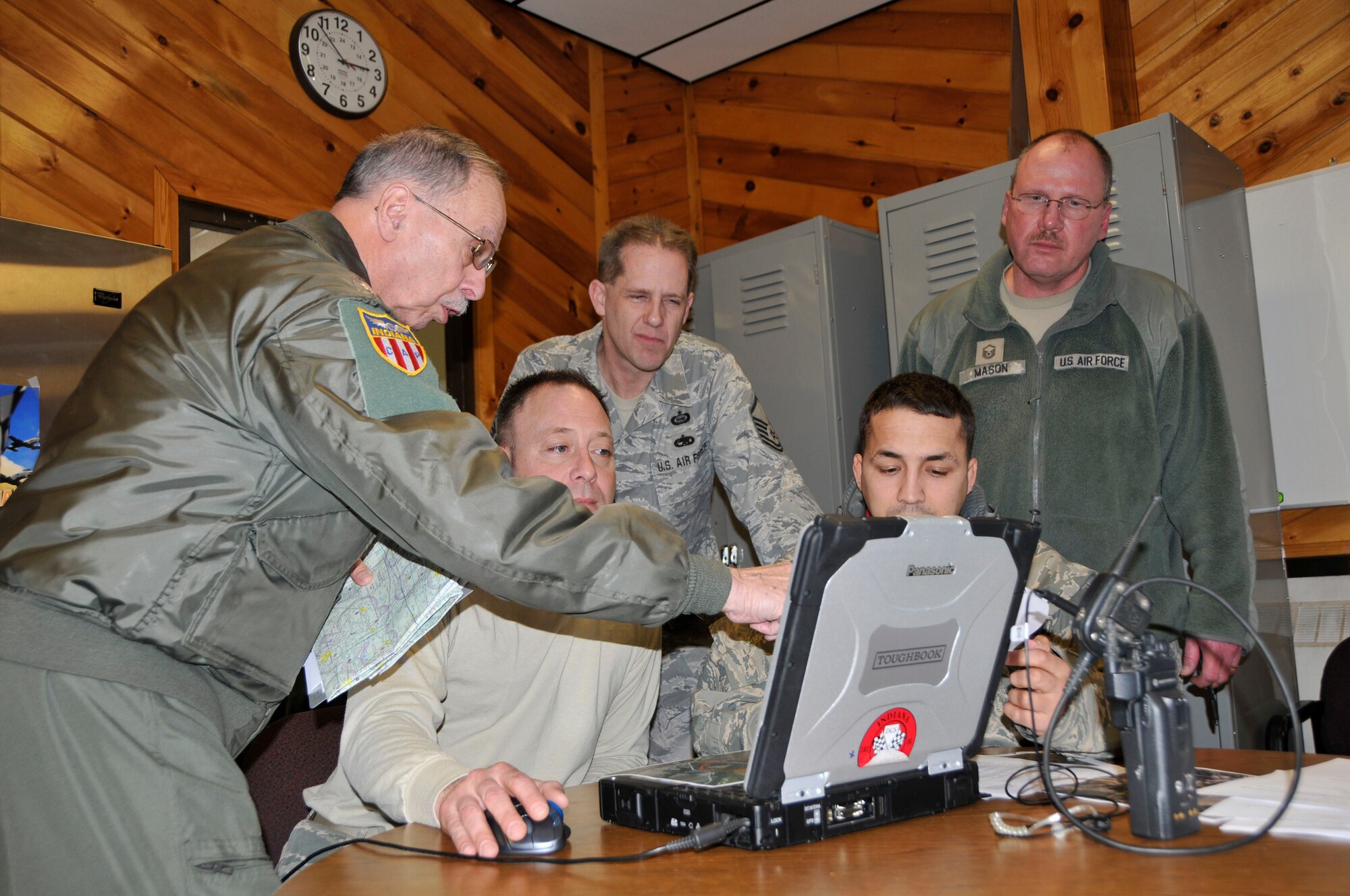 U.S. Air Force airmen assigned to the 181st Intelligence Wing, Indiana Air National Guard and Lt. Col. Reginald H. Paul, Civil Air Patrol pilot, conduct pre-mission planning prior to the Operation Blue Ridge Incident Analysis and Assessment mission over the central Indiana Feb. 21, 2014. The 181st IW deployed an Aerial Collections Team to conduct aerial assessment of flooding in Tippecanoe and Fulton Counties in order to provide Indiana Department of Homeland Security with an accurate assessment of flooding.  The 181st Intelligence Wing is crucial to State domestic response. (U.S. Air National Guard photo by Senior Master Sgt. John S. Chapman/Released)