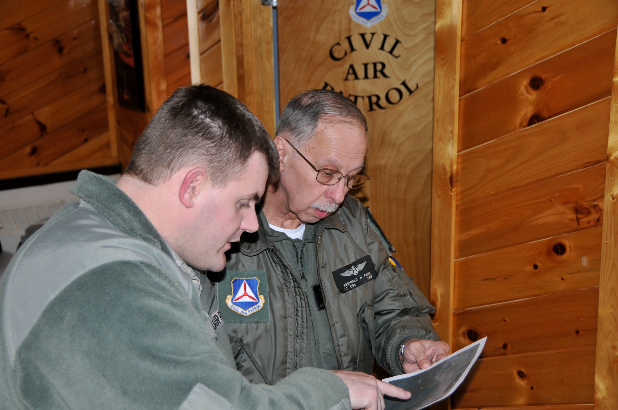 U.S. Air Force Master Sgt. Eric Moore 113th Weather Flight, 181st Intelligence Wing, Indiana Air National Guard briefs Lt. Col. Reginald H. Paul, Civil Air Patrol pilot, on the weather conditions in central Indiana prior to the Operation Blue Sky sortie Feb. 21, 2014. The 181st IW deployed an Aerial Collections Team to conduct aerial assessment of flooding in Tippecanoe and Fulton Counties in order to provide Indiana Department of Homeland Security with an accurate assessment of flooding.  The 181st Intelligence Wing is crucial to State domestic response. (U.S. Air National Guard photo by Senior Master Sgt. John S. Chapman/Released)
