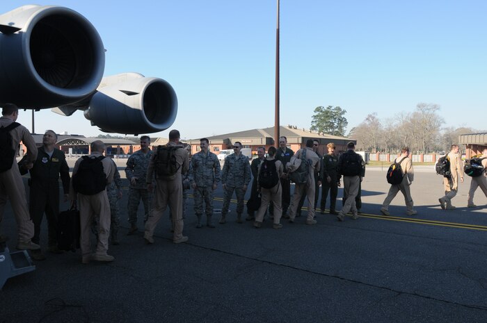 Joint Base Charleston leadership greets members of the 16th Airlift Squadron as they exit a C-17 Globmaster III following a 60-day deployment. While deployed crews flew and supported, more than 1,050 sorties, delivered more than 40 million pounds of cargo to include: 1,135 rolling stock, 2,397 pallets and more than 17,000 passengers. (U.S. Air Force photo/Capt. Sean Perry)