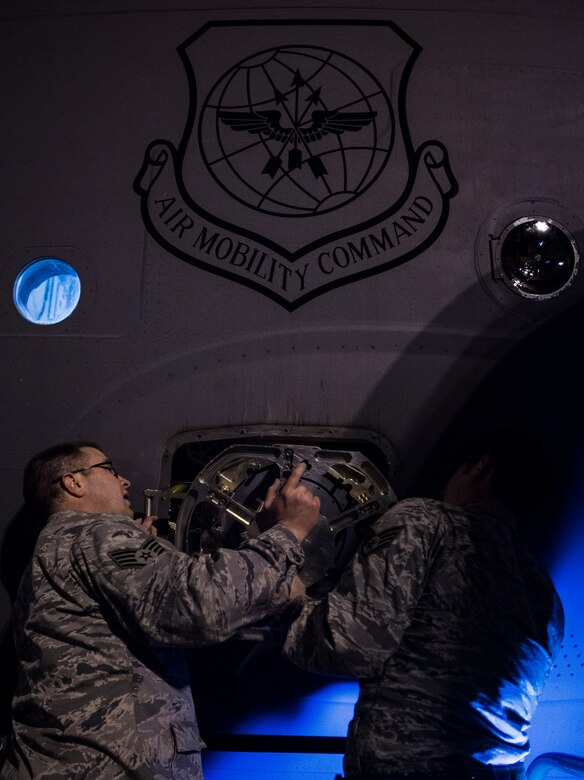 Staff Sgt. Ryan Tobkin and Staff Sgt. Ryan Jordan, 437th Aircraft Maintenance Squadron electronic warfare systems technicians, replace the infrared countermeasure housing on a C-17 Globemaster III March 3, 2014, at Joint Base Charleston – Air Base, S.C. The infrared countermeasure is used to stop homing missiles or devices from striking the aircraft. (U.S. Air Force photo/ Senior Airman Dennis Sloan)