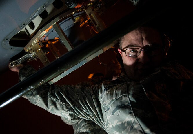 Staff Sgt. Ryan Tobkin, 437th Aircraft Maintenance Squadron electronic warfare systems technician, holds an infrared countermeasure device in place while Staff Sgt. Ryan Jordan, 437th AMX electronic warfare systems technician, replaces the part on a C-17 Globemaster III March 3, 2014, at Joint Base Charleston – Air Base, S.C. The infrared countermeasure is used to stop homing missiles or devices from striking the aircraft. (U.S. Air Force photo/ Senior Airman Dennis Sloan)