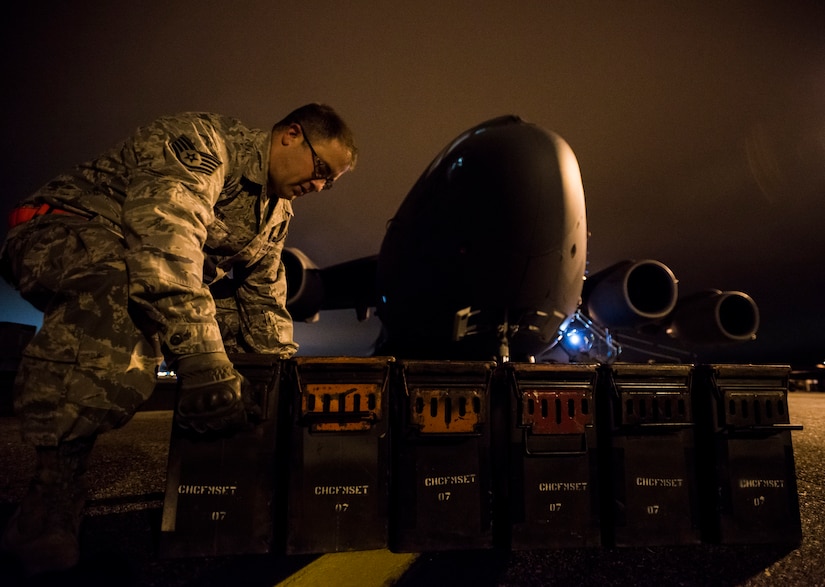 Staff Sgt. Ryan Tobkin, 437th Aircraft Maintenance Squadron electronic warfare systems technician, downloads crates of flares off of a C-17 Globemaster III before replacing the infrared countermeasure housing on the aircraft March 3, 2014, at Joint Base Charleston – Air Base, S.C. The infrared countermeasure is used to stop homing missiles or devices from striking the aircraft. (U.S. Air Force photo/ Senior Airman Dennis Sloan)