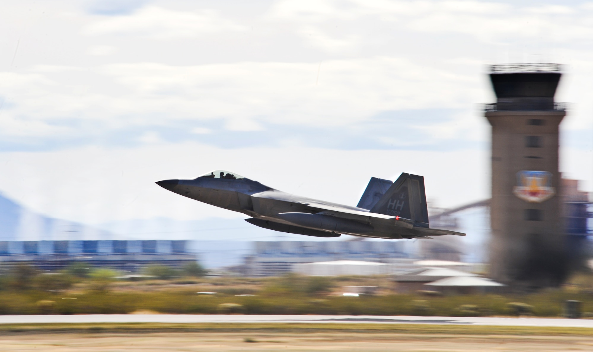 An F-22 Raptors from Hickam Air Force Base, Hawaii, departs Davis-Monthan Air Force Base., Ariz., March 2, 2014. Four F-22 Raptors in transient to Joint Base Pearl Harbor-Hickam, Hawaii, were diverted here March 1. The Air Combat Command F-22 Raptor Demonstration Team worked with the Holloman AFB Maintenance Recovery Team to put the Raptors back in the air. (U.S. Air Force photo by Senior Airman Justin S. Veazie/Released)