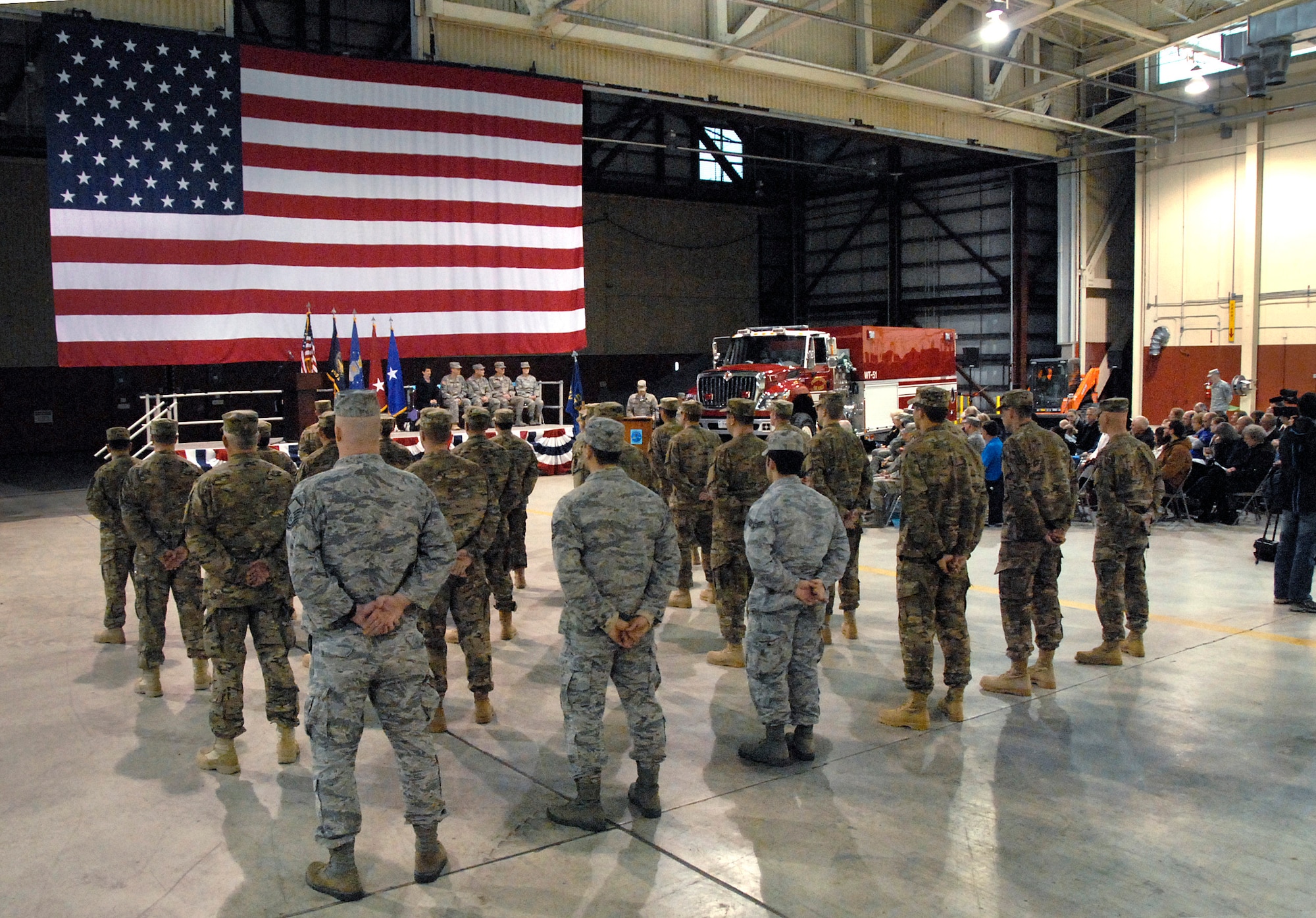 Airmen from the 142nd Fighter Wing Civil Engineer Squadron take part in a formal mobilization ceremony, March 1, 2014, held at the Portland Air National Guard Base, Ore. (Air National Guard photo by Tech. Sgt. John Hughel, 142nd Fighter Wing Public Affairs/Released)
