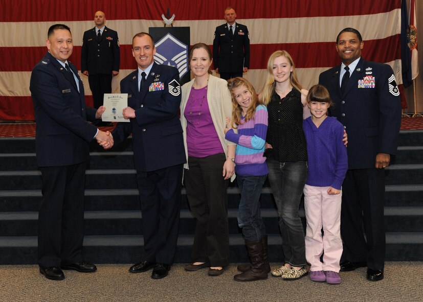 Master Sgt. Jakob Kurtz, Air Force Global Strike Command, receives a certificate of promotion from Col. Rey Ermitano, AFGSC director of safety, and Chief Master Sgt. Larry Tolliver, AFGSC Judge Advocate, during the February Wing Promotion Ceremony on Barksdale Air Force Base, La., Feb. 28, 2014. (U.S. Air Force photo/Senior Airman Joseph A. Pagán Jr.)