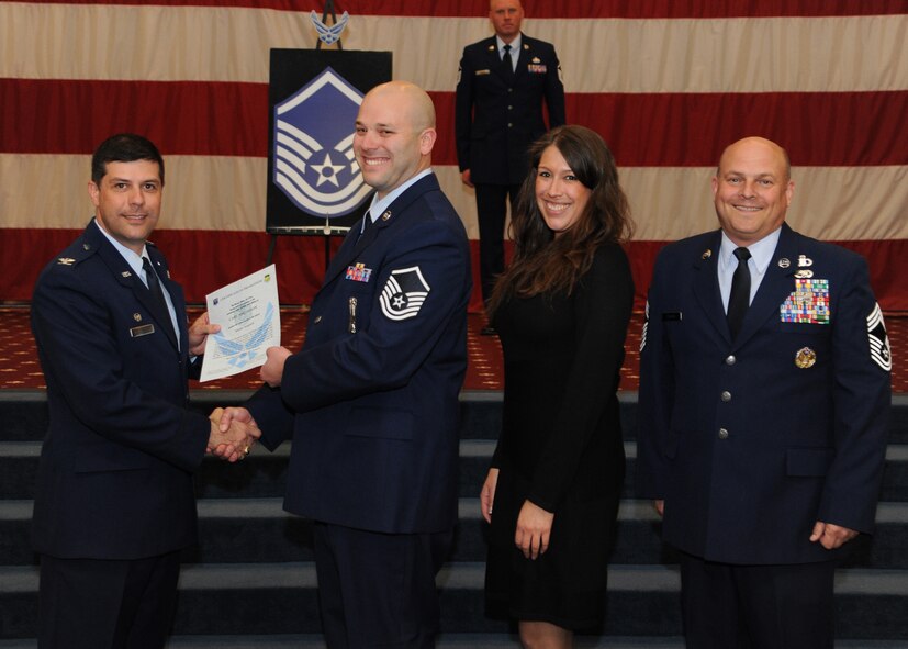 Master Sgt. Carl Smithson, 49th Test and Evaluation Squadron, receives a certificate of promotion from Col. Andrew Gebara, 2nd Bomb Wing commander, and Chief Master Sgt. Stephen Lebrun, 2nd Operations Group, during the February Wing Promotion Ceremony on Barksdale Air Force Base, La., Feb. 28, 2014. (U.S. Air Force photo/Senior Airman Joseph A. Pagán Jr.)