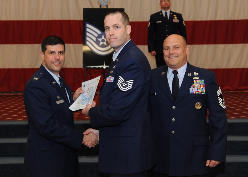 Tech. Sgt. Timothy Jeter, 26th Operational Weather Squadron, receives a certificate of promotion from Col. Andrew Gebara, 2nd Bomb Wing commander, and Chief Master Sgt. Stephen Lebrun, 2nd Operations Group, during the February Wing Promotion Ceremony on Barksdale Air Force Base, La., Feb. 28, 2014. (U.S. Air Force photo/Senior Airman Joseph A. Pagán Jr.)