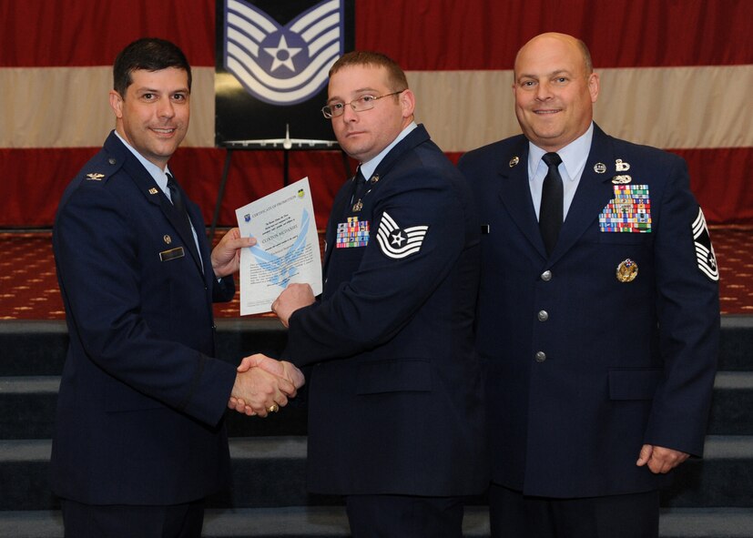 Tech. Sgt. Clinton McDaniel, 2nd Civil Engineer Squadron, receives a certificate of promotion from Col. Andrew Gebara, 2nd Bomb Wing commander, and Chief Master Sgt. Stephen Lebrun, 2nd Operations Group, during the February Wing Promotion Ceremony on Barksdale Air Force Base, La., Feb. 28, 2014. (U.S. Air Force photo/Senior Airman Joseph A. Pagán Jr.)