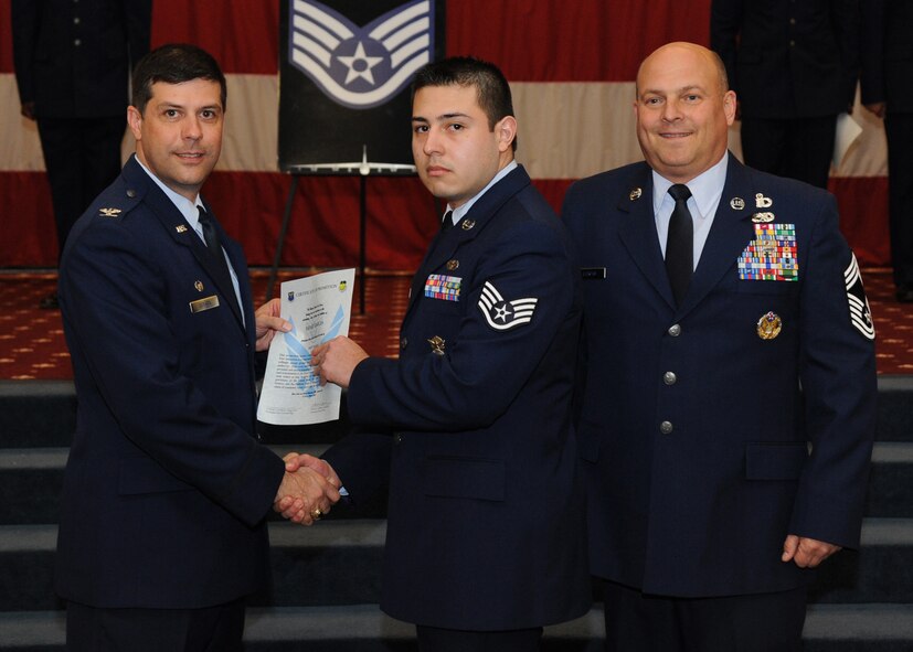 Staff Sgt. Israel Garcia, 2nd Security Forces Squadron, receives a certificate of promotion from Col. Andrew Gebara, 2nd Bomb Wing commander, and Chief Master Sgt. Stephen Lebrun, 2nd Operations Group, during the February Wing Promotion Ceremony on Barksdale Air Force Base, La., Feb. 28, 2014. (U.S. Air Force photo/Senior Airman Joseph A. Pagán Jr.)