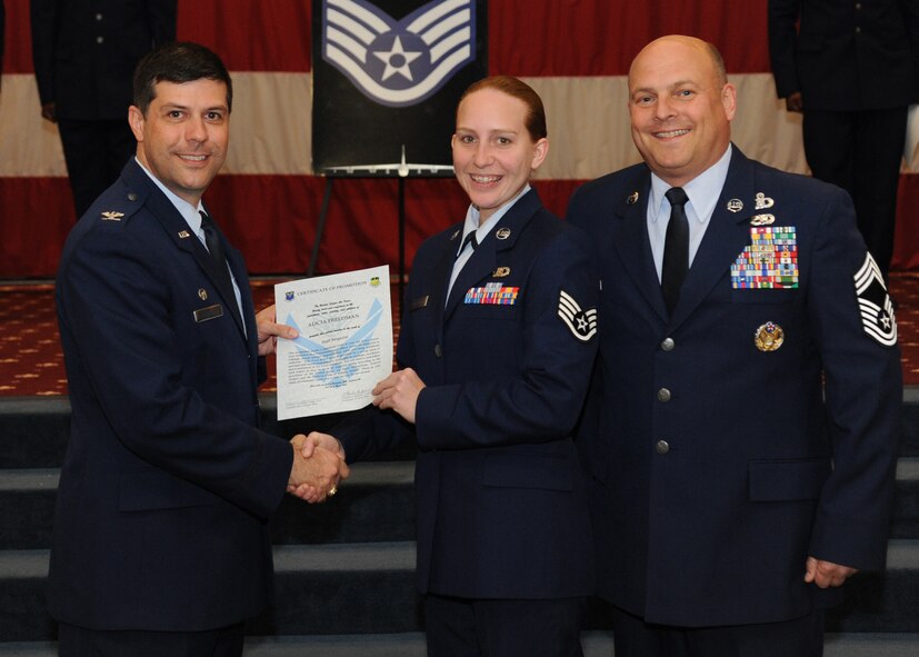 Staff Sgt. Alicia Freedman, 2nd Operations Support Squadron, receives a certificate of promotion from Col. Andrew Gebara, 2nd Bomb Wing commander, and Chief Master Sgt. Stephen Lebrun, 2nd Operations Group, during the February Wing Promotion Ceremony on Barksdale Air Force Base, La., Feb. 28, 2014. (U.S. Air Force photo/Senior Airman Joseph A. Pagán Jr.)