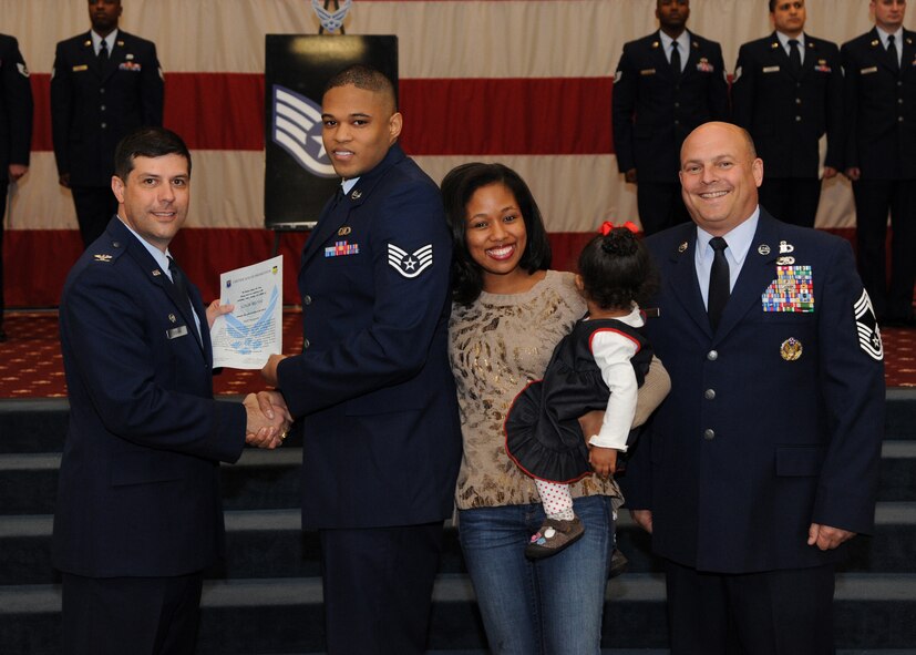 Staff Sgt. Colin Belyeu, 2nd Operations Support Squadron, receives a certificate of promotion from Col. Andrew Gebara, 2nd Bomb Wing commander, and Chief Master Sgt. Stephen Lebrun, 2nd Operations Group, during the February Wing Promotion Ceremony on Barksdale Air Force Base, La., Feb. 28, 2014. (U.S. Air Force photo/Senior Airman Joseph A. Pagán Jr.)