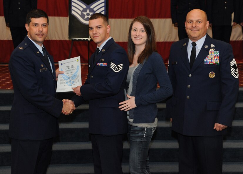 Staff Sgt. Anthony Stafford, 2nd Maintenance Squadron, receives a certificate of promotion from Col. Andrew Gebara, 2nd Bomb Wing commander, and Chief Master Sgt. Stephen Lebrun, 2nd Operations Group, during the February Wing Promotion Ceremony on Barksdale Air Force Base, La., Feb. 28, 2014. (U.S. Air Force photo/Senior Airman Joseph A. Pagán Jr.)