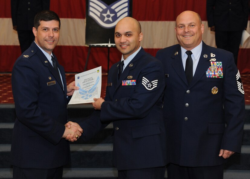 Staff Sgt. Jonathan Silva, 2nd Maintenance Group, receives a certificate of promotion from Col. Andrew Gebara, 2nd Bomb Wing commander, and Chief Master Sgt. Stephen Lebrun, 2nd Operations Group, during the February Wing Promotion Ceremony on Barksdale Air Force Base, La., Feb. 28, 2014. (U.S. Air Force photo/Senior Airman Joseph A. Pagán Jr.)