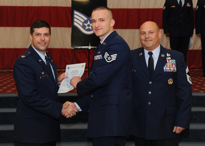 Staff Sgt. Matthew Lokitis, 2nd Maintenance Group, receives a certificate of promotion from Col. Andrew Gebara, 2nd Bomb Wing commander, and Chief Master Sgt. Stephen Lebrun, 2nd Operations Group, during the February Wing Promotion Ceremony on Barksdale Air Force Base, La., Feb. 28, 2014. (U.S. Air Force photo/Senior Airman Joseph A. Pagán Jr.)