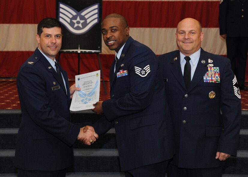 Staff Sgt. Devin Wigley, 2nd Force Support Squadron, receives a certificate of promotion from Col. Andrew Gebara, 2nd Bomb Wing commander, and Chief Master Sgt. Stephen Lebrun, 2nd Operations Group, during the February Wing Promotion Ceremony on Barksdale Air Force Base, La., Feb. 28, 2014. (U.S. Air Force photo/Senior Airman Joseph A. Pagán Jr.)