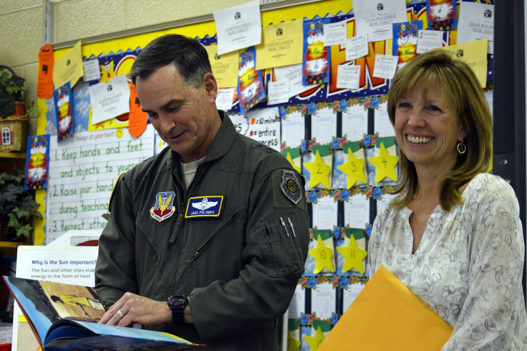 U.S. Air Force Maj. Gen. Jake Polumbo, Ninth Air Force commander, along with his wife Sandra, read to a classroom of elementary students, Sumter S.C., March 3, 2014. The couple went to Millwood Elementary School as part of read across America day, to encourage children to read and also to raise awareness on the importance of a good education. (U.S. Air Force photo by Senior Airman Ashley L. Gardner)