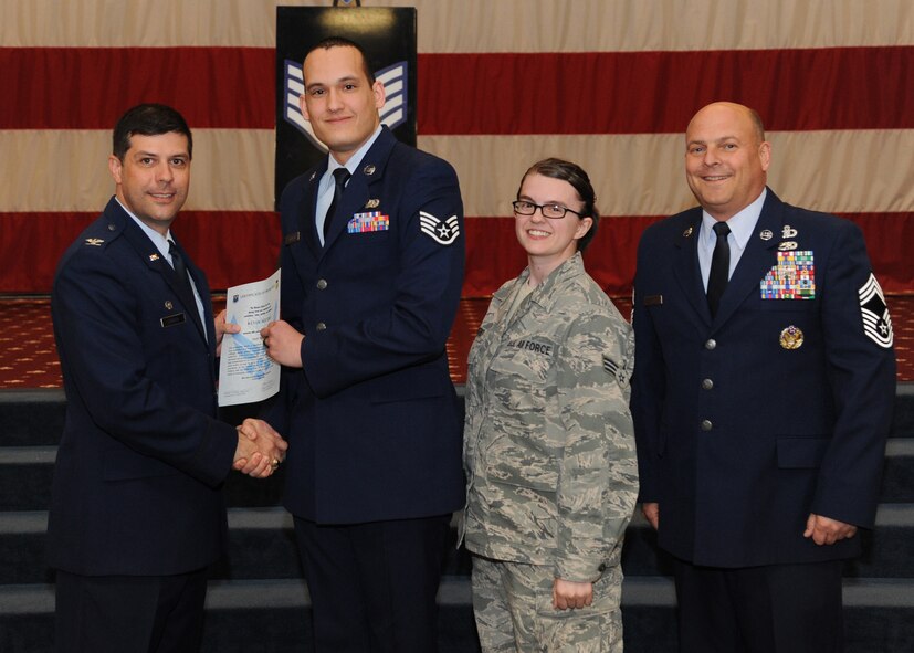 Staff Sgt. Kevin Aquero, 2nd Communications Squadron, receives a certificate of promotion from Col. Andrew Gebara, 2nd Bomb Wing commander, and Chief Master Sgt. Stephen Lebrun, 2nd Operations Group, during the February Wing Promotion Ceremony on Barksdale Air Force Base, La., Feb. 28, 2014. (U.S. Air Force photo/Senior Airman Joseph A. Pagán Jr.)